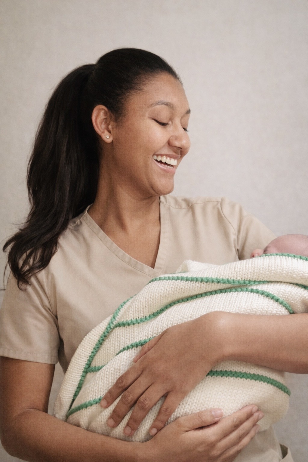 Sleeping newborn wrapped in a soft cream blanket